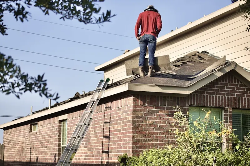 Professional roofer working on a residential roof in Suffolk Pines